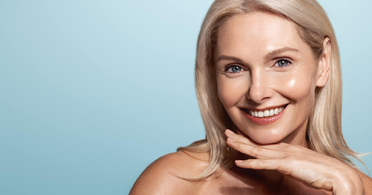 Woman with smooth, glowing skin from Epionce, and blonde hair, gently resting her chin on her hand in Vancouver, WA.