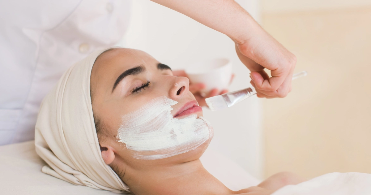 A woman receives a spa facial in Vancouver, WA, as a technician applies a white mask to her face.